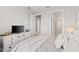 Bright bedroom with soft bedding, a decorative dresser, and ample closet space at 2577 Buckthorn Loop, North Port, FL 34289
