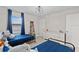 bedroom with 2 beds, ladder bookshelf and blue curtains at 2577 Buckthorn Loop, North Port, FL 34289