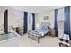 bedroom with bed, desk, blue curtains, and a bright window at 2577 Buckthorn Loop, North Port, FL 34289