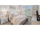 Comfortable bedroom with neutral decor, a plush bed, and abundant natural light at 2577 Buckthorn Loop, North Port, FL 34289