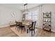 Cozy dining area features a stylish table setting, a comfortable bench, and modern decor accents at 2577 Buckthorn Loop, North Port, FL 34289