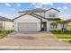 Charming two-story home featuring a two-car garage and a beautifully paved driveway at 2577 Buckthorn Loop, North Port, FL 34289