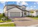 Charming two-story home with a well-maintained lawn and a paver driveway at 2577 Buckthorn Loop, North Port, FL 34289