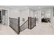 Upstairs hallway featuring a wooden railing and spindles at 2577 Buckthorn Loop, North Port, FL 34289