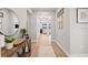 Spacious hallway with wood flooring, light walls, leading into the living room at 2577 Buckthorn Loop, North Port, FL 34289