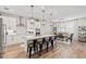 Modern kitchen featuring a large island with seating, pendant lights, and stainless steel appliances at 2577 Buckthorn Loop, North Port, FL 34289