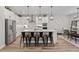 Well-lit kitchen with a spacious island, stainless steel appliances, and seamless flow to the dining area at 2577 Buckthorn Loop, North Port, FL 34289