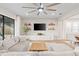 Bright and airy living room featuring a large sectional sofa, media center, and natural light at 2577 Buckthorn Loop, North Port, FL 34289