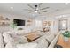 Comfortable living room with a sectional sofa that opens to the dining room at 2577 Buckthorn Loop, North Port, FL 34289