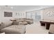 Cozy living area with a comfortable sectional sofa, game table, and large windows at 2577 Buckthorn Loop, North Port, FL 34289