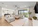 Spacious living area with a large sectional sofa and a view of the backyard at 2577 Buckthorn Loop, North Port, FL 34289