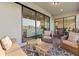 Inviting covered lanai with comfortable seating, a wood table, and view of the backyard at 2577 Buckthorn Loop, North Port, FL 34289