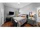 A cozy bedroom featuring a comfortable bed, dark wood floors, and a large window at 3117 W Lawn Ave, Tampa, FL 33611