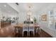 Bright dining room boasting hardwood floors, white wainscoting, stylish chandelier, and large windows at 3117 W Lawn Ave, Tampa, FL 33611