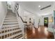 An inviting foyer featuring hardwood floors and a staircase leading to the upper level at 3117 W Lawn Ave, Tampa, FL 33611