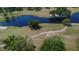 Scenic aerial view of a pristine golf course with ponds, lush greenery, and manicured fairways at 322 Northway Dr, Sun City Center, FL 33573