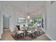 Elegant dining room with large windows, stylish chandelier, and a glass-top table for six at 322 Northway Dr, Sun City Center, FL 33573