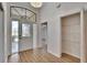 Bright foyer with wood floors, closet, transom window above the front door and a chandelier at 322 Northway Dr, Sun City Center, FL 33573