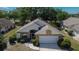 Charming home featuring manicured landscaping, attached two-car garage, and a well-maintained lawn at 322 Northway Dr, Sun City Center, FL 33573