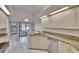 Bright kitchen featuring granite countertops, modern appliances, and a seamless connection to the outdoors at 322 Northway Dr, Sun City Center, FL 33573