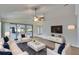 Bright living room featuring a ceiling fan, recessed lighting, comfortable seating, and a wall-mounted TV at 322 Northway Dr, Sun City Center, FL 33573