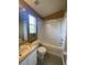 Bathroom featuring a white vanity, framed mirror, and a shower/tub combo at 3441 Santa Rita Lane, Land O Lakes, FL 34639