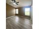 Bedroom featuring vinyl flooring, a ceiling fan, and lots of natural light from two windows at 3441 Santa Rita Lane, Land O Lakes, FL 34639