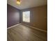 Neutral bedroom featuring hardwood flooring, ceiling fan, and window providing natural light at 3441 Santa Rita Lane, Land O Lakes, FL 34639