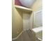 Hallway view featuring wood look floors and white doors at 3441 Santa Rita Lane, Land O Lakes, FL 34639
