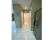 Hallway view featuring tile flooring and access to a half bathroom at 3441 Santa Rita Lane, Land O Lakes, FL 34639
