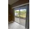 A glass slider opens to a screened patio, blending indoor and outdoor living spaces seamlessly at 3441 Santa Rita Lane, Land O Lakes, FL 34639