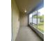 Relaxing screened porch with neutral walls, door, and view of a yard with white fencing at 3441 Santa Rita Lane, Land O Lakes, FL 34639