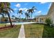 Waterfront backyard features a sparkling pool, lush landscaping, and dock access for boating at 3945 Versailles Dr, Tampa, FL 33634