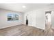 Sunlit bedroom features wood-look floors, an ensuite bathroom, and canal views at 3945 Versailles Dr, Tampa, FL 33634