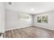 A cozy bedroom with ample light features modern, wood-look floors and neutral walls at 3945 Versailles Dr, Tampa, FL 33634