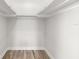 Walk-in closet offering great storage potential with wood-look floors and bright neutral paint at 3945 Versailles Dr, Tampa, FL 33634