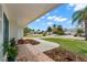View from the front porch of a quiet, tree-lined street and meticulously landscaped yard at 3945 Versailles Dr, Tampa, FL 33634