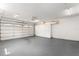 Spacious garage with epoxy flooring, ample storage, and an automatic door at 3945 Versailles Dr, Tampa, FL 33634