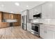 Gourmet kitchen features stainless steel appliances and two-tone cabinetry at 3945 Versailles Dr, Tampa, FL 33634