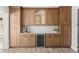 Kitchenette features wine cooler, white tile backsplash, and wood cabinetry at 3945 Versailles Dr, Tampa, FL 33634