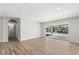 Bright living area with wood-look flooring and sliding glass doors that offer scenic waterfront views and plenty of light at 3945 Versailles Dr, Tampa, FL 33634
