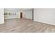 Bright living room featuring wood-look flooring, base molding, and neutral paint, ready for personalization at 3945 Versailles Dr, Tampa, FL 33634