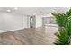 Expansive living room with wood-look flooring that seamlessly transitions to outdoor views of the pool and waterway at 3945 Versailles Dr, Tampa, FL 33634