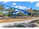 Community playground featuring modern equipment, shade sails, and a safe, wood-chip ground cover at 3945 Versailles Dr, Tampa, FL 33634
