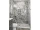 This stylish bathroom boasts a stunning marble shower with glass enclosure and updated fixtures at 3945 Versailles Dr, Tampa, FL 33634