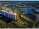Picturesque aerial view of a luxury condo complex nestled beside a tranquil river and lush greenery at 4516 Seagull Dr # 615, New Port Richey, FL 34652