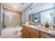 This bathroom offers granite counters, wood cabinets, a shower/tub combination, and decorative wall art at 4516 Seagull Dr # 615, New Port Richey, FL 34652