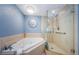 This spacious bathroom has a soaking tub, glass shower and decorative sunburst wall decor at 4516 Seagull Dr # 615, New Port Richey, FL 34652