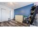 This secondary bedroom has wood floors, a ceiling fan, and built-in murphy bed with storage at 4516 Seagull Dr # 615, New Port Richey, FL 34652