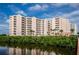 Waterfront condominium complex with multiple balconies overlooking lush greenery and tranquil waters, creating a serene retreat at 4516 Seagull Dr # 615, New Port Richey, FL 34652